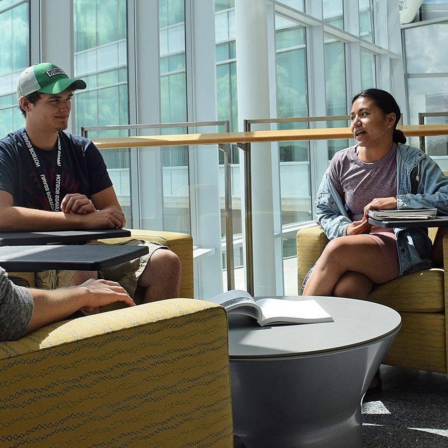 Two students talk in ISC lounge.