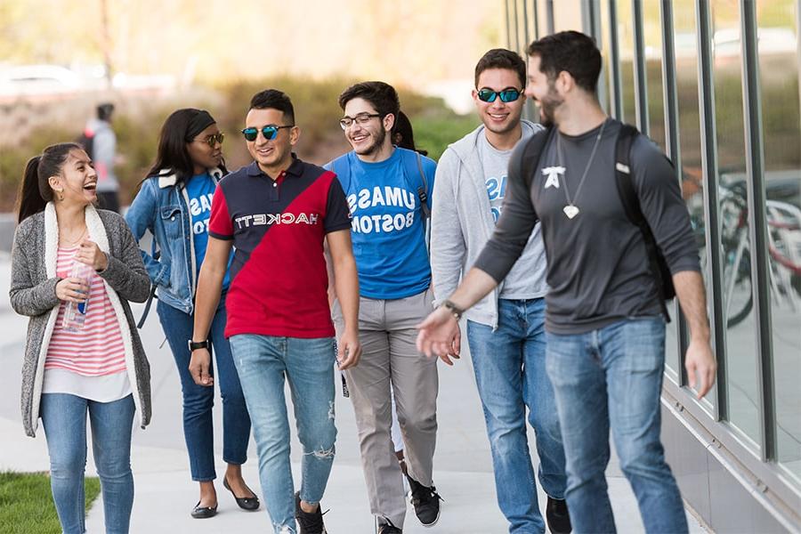 Group of diverse students walking laughing